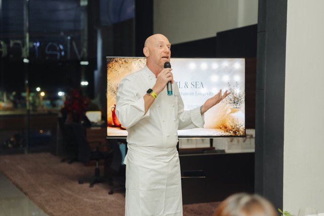 Chef David Laris speaking to guests at a Slice Wellbeing catered dinner in Phuket